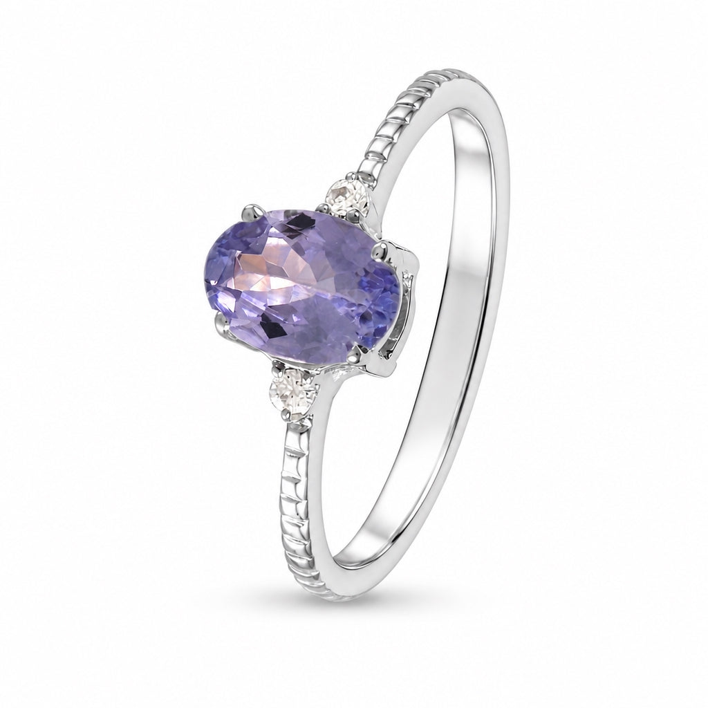 Anillo oro blanco con tanzanita y diamantes laterales