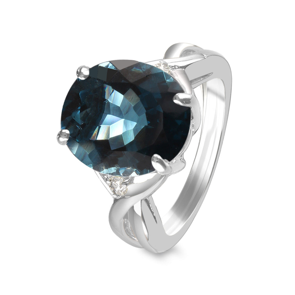 Anillo con topacio london y diamantes laterales