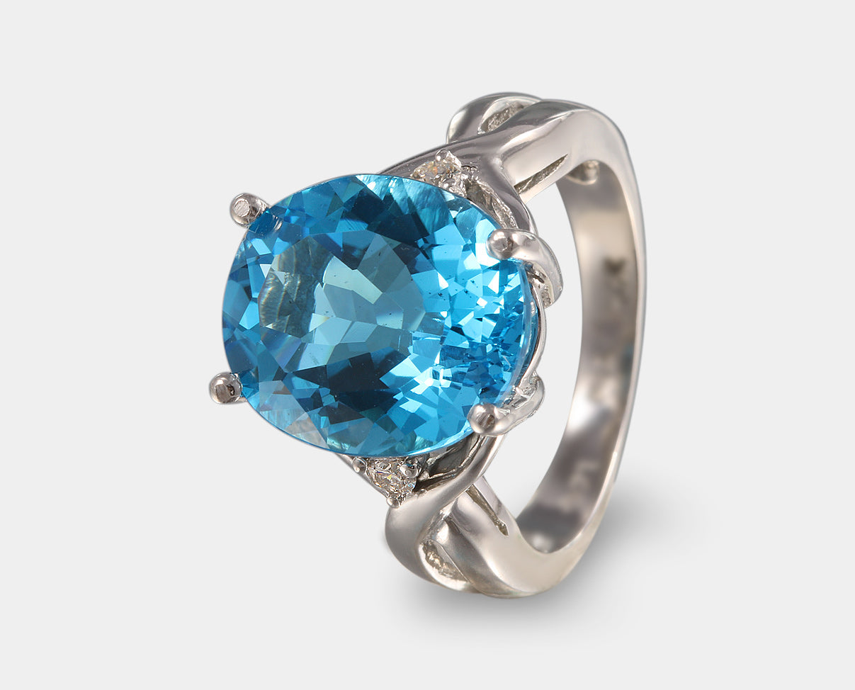 Espectacular anillo de oro blanco con topacio azul y diamantes laterales. Anillos especiales con piedras naturales y gemas